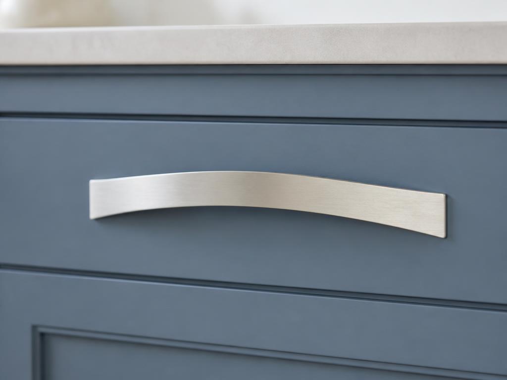 DH026BSN brushed nickel bow pull fitted to a dusty blue shaker drawer front